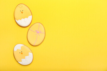 Tasty Easter cookies on yellow background
