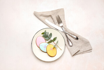 Beautiful table setting for Easter celebration with eucalyptus branch on white background