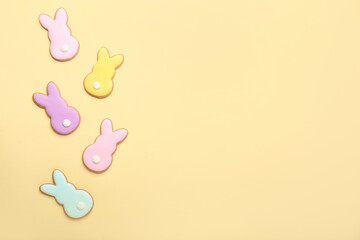 Delicious Easter cookies in shape of bunny on beige background