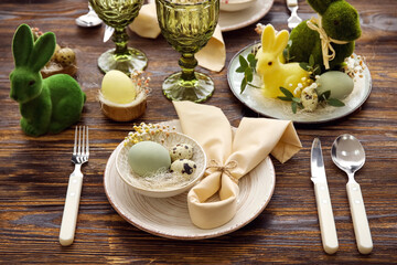Stylish table setting for Easter celebration on wooden background