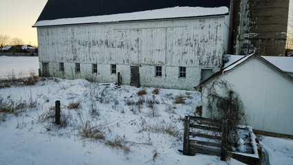 Old abandoned barn and winter landscape