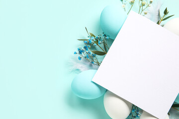 Composition with blank card, flowers and Easter eggs on color background
