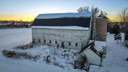 Old abandoned barn and winter landscape