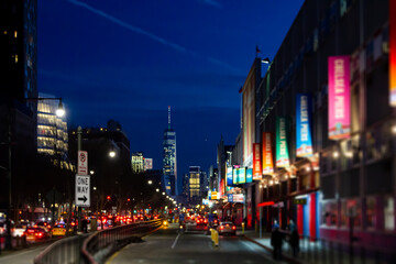 Fototapeta na wymiar New York City night street scene at Chelsea Pier with blurred lights of the buildings and cars