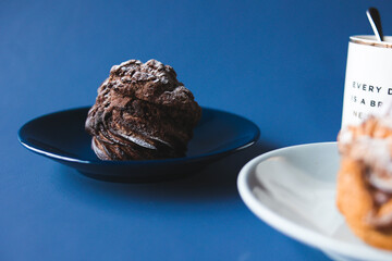 Coffee break with chocolate cream puff and original cream puff