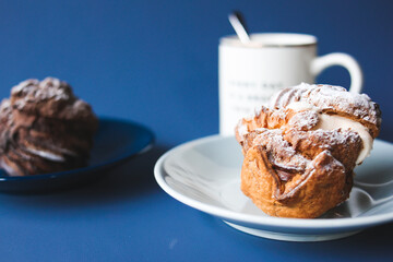 Coffee break with chocolate cream puff and original cream puff