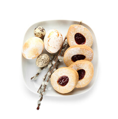 Plate with delicious cookies for Easter with eggs and willow branches on white background