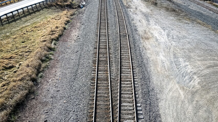 Fototapeta na wymiar Pair of railroad tracks surrounded by gravel