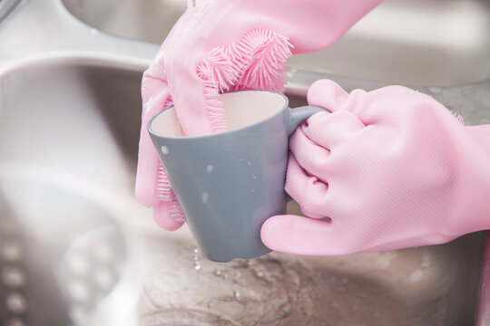 Pink Colorful Rubber Gloves Cleaning A Mug Cup