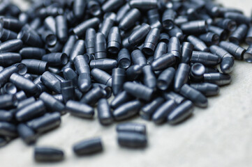 Small caliber hunter bullets lie on light fabric sheet