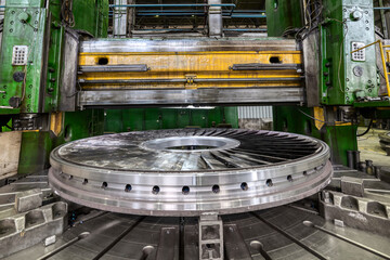 Processed part with vertical turning lathe machine in shop