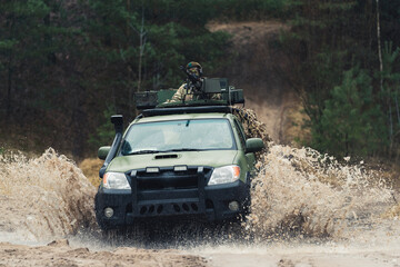 Heavily armed patrol mounted with machine weaponry of British military . High quality photo