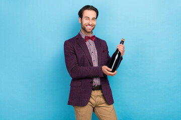 Photo of young man hold bottle of wine event celebration holiday isolated over blue color background