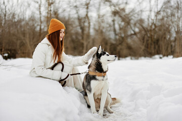 portrait of a woman outdoors in a field in winter walking with a dog Lifestyle