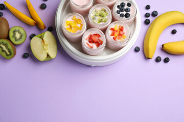Yogurt maker with jars and different fruits on lilac background, flat lay. Space for text