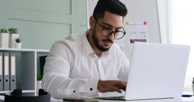 Businessman busy working on laptop at office