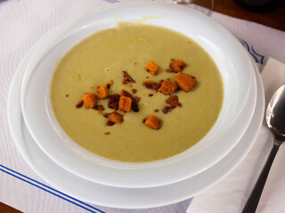Healthy delicious lunch. Dietary cream soup of vegetables garnished with toasted bread ..