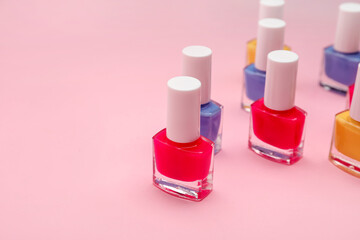 Set of nail polish bottles on color background