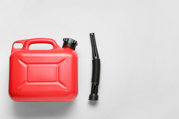 Plastic canister and rubber nozzle on light background