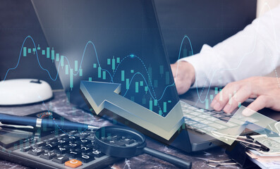 Businessman using computer analyzing sales data and economic growth graph chart. Business planning and strategy. Analysing trading of exchange. Financial and banking. double exposure 