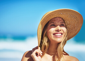 What an amazing summers day. Shot of a gorgeous young woman in a bikini at the beach.