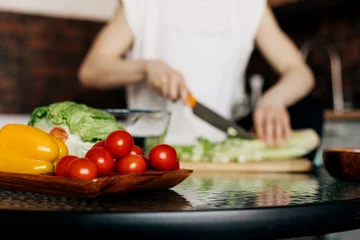Fotobehang Fresh vegetables on the kitchen table for healthy food preparation © Sviatlana