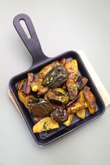 Baingan masala. Indian Potato and aubergine curry. Homemade Indian spicy eggplant and potato curry served in a white plate. Copy space.