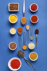 Set of different spices on blue background