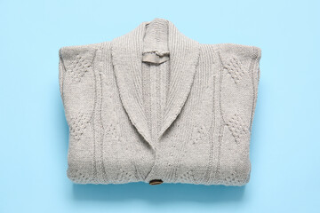 Stylish sweater on blue background