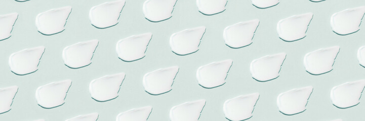 Smears of cream on a blue background.