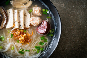 Vietnamese Rice Noodles Soup with Vietnamese Sausage served vegetables and crispy onion
