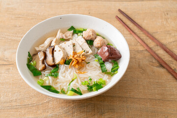 Vietnamese Rice Noodles Soup with Vietnamese Sausage served vegetables and crispy onion