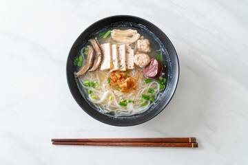 Vietnamese Rice Noodles Soup with Vietnamese Sausage served vegetables and crispy onion
