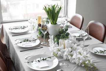 Dining table with beautiful setting, flowers and blank cards