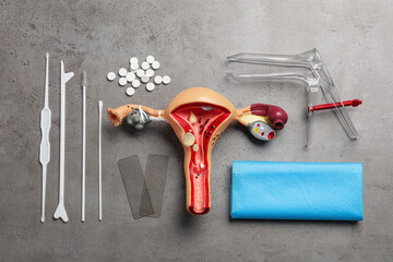 Gynecological examination kit on grey table, flat lay - obrazy, fototapety, plakaty