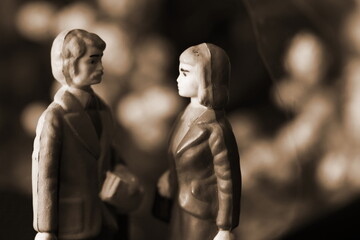 Fototapeta na wymiar Miniature figure couple model toy put in front of flower background scene.