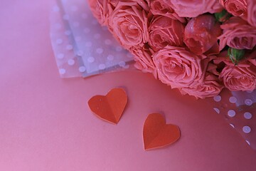 bouquet of tea-colored roses on a pink background with red hearts. Postcard. Desktop wallpaper. Valentine's Day