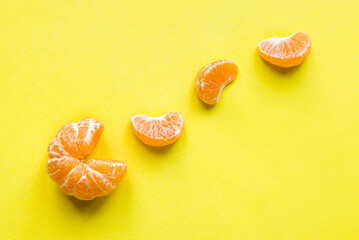 Mandarin pac man and mandarin slice on a yellow background. Tangerine Vitamin C