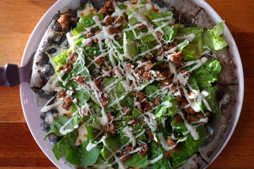 Seeing spinach pizza from the top.