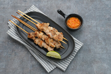 Sate Taichan, Grilled Chicken Satay without peanut sauce or soy sauce. Served on plate with sambal (chilli sauce). Selected focus.
