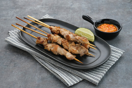 Sate Taichan, Grilled Chicken Satay without peanut sauce or soy sauce. Served on plate with sambal (chilli sauce). Selected focus.
