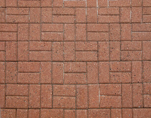    A section of the sidewalk surface lined with paving slabs of red-brown color   