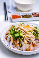 A plate of shredded chicken noodles in Shanghai sesame sauce