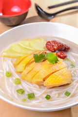 A Bowl Of The Rice Noodles and Sliced Chicken in Fish Soup