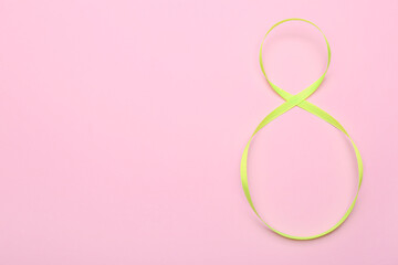 Obraz na płótnie Canvas Figure 8 made of ribbon on pink background. International Women's Day celebration