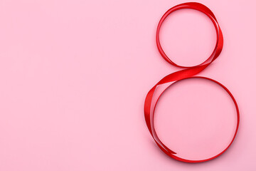 Figure 8 made of ribbon for International Women's Day celebration on pink background