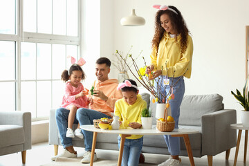 Happy family spending time together at home on Easter day
