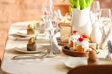 Fototapeta na wymiar Beautiful setting, Easter cakes and eggs on dining table