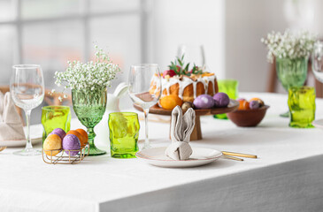 Plate with cute bunny made of napkin on table served for Easter celebration