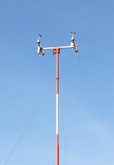 Wind speed sensors against a deep blue sky